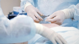 The hands of a surgeon can be seen in this undated file photo. An Ont. surgeon has been suspended for 18 months after he directed his colleague, a female X-ray technician, to perform an exam of his genitals with proper requisition, the OPSDT found in a decision published Friday. (Anna Shvets/Pexels)