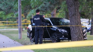 A police officer at the scene of a shooting on Tuesday in the area of Markham and Ellesmere roads shortly before 5 p.m. (CP24/ Simon Sheehan). 
