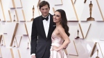 FILE - Ashton Kutcher, left, and Mila Kunis arrive at the Oscars on Sunday, March 27, 2022, at the Dolby Theatre in Los Angeles. The couple are apologizing for character letters they wrote on behalf of actor Danny Masterson ahead of this week's sentencing of their fellow "That '70s Show" cast member. A judge in Los Angeles on Thursday, Sept. 7, 2023, sentenced Masterson to 30 years to life in prison for raping two women in 2003. (Photo by Jordan Strauss/Invision/AP, File)