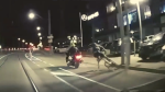 Dash camera footage shows a motorcyclist hitting a biker in downtown Toronto.