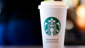 A single-use cup made from 30% post-consumer recycled fiber sits at a Starbucks retail location, Wednesday, June 28, 2023, in Seattle. The company's goal is to cut waste, water use and carbon emissions in half by 2030. (AP Photo/Lindsey Wasson)