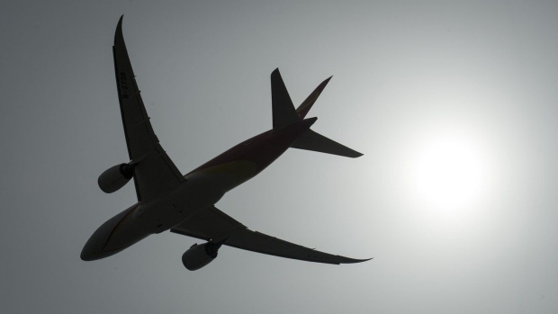 A plane is silhouetted as it takes off from Vancouver International Airport in Richmond, B.C., on May 13, 2019. THE CANADIAN PRESS/Jonathan Hayward