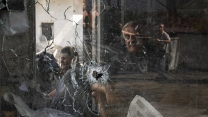 A bullet hole is seen in a shop window following an Israeli military raid in the Jenin refugee camp, West Bank, Wednesday, Sept. 20, 2023. Palestinian health officials say the death toll over a day of fighting between Israel and the Palestinians in the occupied West Bank and the Gaza Strip has risen to six, four from Jenin. The army said that forces carried out a rare strike Tuesday with a suicide drone during the operation and exchanged fire with gunmen in Jenin. (AP Photo/Majdi Mohammed)
