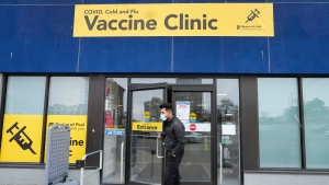 A staff member at a vaccine clinic looks outside the clinic for people waiting to get their COVID-19 vaccine or flu shot during the COVID-19 pandemic, in Mississauga, Ont., on Wednesday, April 13, 2022. THE CANADIAN PRESS/Nathan Denette 