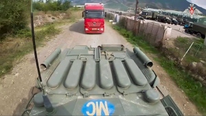In this image made from video released by the Russian Defense Ministry Press Service on Saturday, Sept. 23, 2023, an armored personnel carrier of the Russian peacekeeping contingent accompanies the delivery of humanitarian aid to Nagorno-Karabakh, which has been cut off from supplies since late last year. Russia's Defense Ministry says that ethnic Armenian separatists in Azerbaijan's breakaway region of Nagorno-Karabakh are surrendering their arms to Russian peacekeepers. (Russian Defense Ministry Press Service via AP)