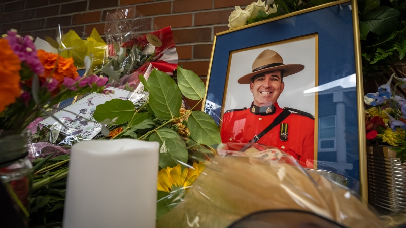 A memorial full of flowers is set up for officer Rick O'Brien, in front of the Ridge Meadows detachment in Maple Ridge B.C., on Saturday, September 23, 2023. O'Brien lost his life during duty in Coquitlam the day before. THE CANADIAN PRESS/Ethan Cairns