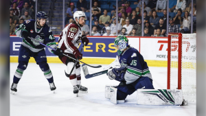 Seattle Thunderbirds goalie Thomas Milic, right, blocks the net as Peterborough Petes forward Connor Lockhart, centre, tries for a rebound while defenceman Sawyer Mynio looks on during second period semifinal CHL Memorial Cup hockey action in Kamloops, B.C., Friday, June 2, 2023.The Vancouver Canucks have signed Mynio to a three-year, entry level contract. THE CANADIAN PRESS/Jeff McIntosh