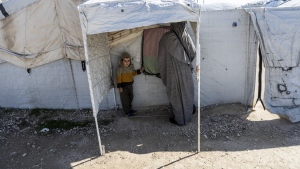 A woman and a child stand in the al-Roj detention camp in northeast Syria Wednesday, Feb. 9, 2022. A lawyer is asking the Federal Court to direct the Canadian government to repatriate a Quebec woman being held in a Syrian detention camp with her six children. THE CANADIAN PRESS/AP-Baderkhan Ahmad