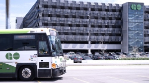 A bus is seen outside the parking lot at the Bramalea GO Station, in Brampton, on Thursday May 11, 2023. Ontario's minister of infrastructure is proposing a new way of funding GO Transit stations that she says will both increase transit service and housing nearby.THE CANADIAN PRESS/Chris Young