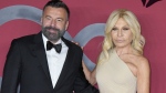 Donatella Versace, right, poses for photographers with Alessandro Zan as they arrive for the CNMI sustainable fashion 2023 awards in Milan, Italy, Sunday, Sept. 24, 2023. Donatella Versace slammed the Italian government for anti-gay policies in a heart-felt speech that referenced her late brother, Gianni Versace, while receiving a fashion award this weekend. (AP Photo/Antonio Calanni)