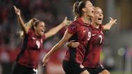 Canada's Jordyn Huitema, 9, celebrates her goal with teammates Julia Groos, right, and Shelina Zadorshy, 4, during second half CONCACAF women's championship soccer series match against Jamaica in Toronto on Tuesday Sept. 26, 2023. THE CANADIAN PRESS/Nathan Denette
