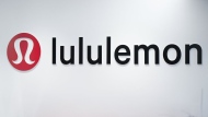 The Lululemon logo is seen on a wall at the company's headquarters in Vancouver on Thursday, May 25, 2023. Lululemon Athletica Inc. says it has struck a five-year partnership with Peloton Interactive Inc. THE CANADIAN PRESS/Darryl Dyck