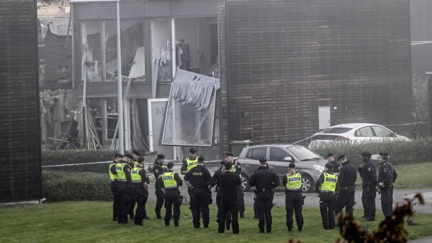 Police stand on the site of a powerful explosion that occurred early Thursday morning Sept. 28, 2023, in a housing area in Storvreta outside Uppsala, Sweden. A 25-year-old woman died in the blast. (Anders Wiklund/TT News Agency via AP)
