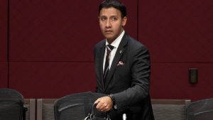 Justice Minister and Attorney General of Canada, Arif Virani moves his bag as he wait to appear before the Senate Standing Committee on Legal and Constitutional Affairs, Wednesday, September 27, 2023 in Ottawa. An association representing Black lawyers in Canada says more Black people will be sent to jail if Liberal government's bail-reform legislation passes as is. THE CANADIAN PRESS/Adrian Wyld