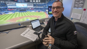 The Toronto Blue Jays' radio rights-holder said Thursday that it will resume traditional in-person coverage of road games if the team makes the playoffs. Toronto Blue Jays announcer Ben Wagner sits in the broadcast booth in Toronto, Sunday, April 10, 2022. THE CANADIAN PRESS/Frank Gunn