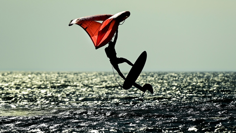 A wing-surfer catches some air on lake Ontario at Cherry Beach on a warm fall day during the COVID-19 pandemic in Toronto on Friday, November 20, 2020. THE CANADIAN PRESS/Nathan Denette 