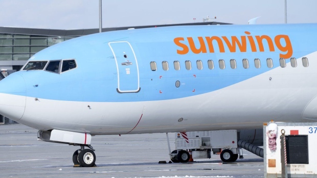 A Sunwing aircraft is parked at Montreal Trudeau airport in Montreal on Wednesday, March 2, 2022.WestJet says it aims to wind down Sunwing Airlines and integrate the low-cost carrier into its mainline business by October of next year. THE CANADIAN PRESS/Paul Chiasson