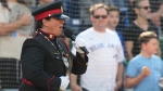 Sgt. Chantal Larocque sings "O Canada'" in English, French and Algonquin at Rogers Centre before American League MLB baseball action against Tampa Bay Rays in Toronto, Saturday, Sept. 30, 2023. Larocque, who is an officer with the Anishinabek Police Service, sang the national anthem on Saturday as part of the Major League Baseball team's ceremony for National Truth and Reconciliation Day. THE CANADIAN PRESS/Frank Gunn 