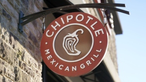 FILE - The Chipotle Mexican Grill logo hangs outside a restaurant location, Dec. 20, 2022. On Wednesday, Sept. 27, 2023, a federal agency sued the restaurant chain Chipotle, accusing it of religious harassment and retaliation after a manager at a Kansas location forcibly removed an employee's hijab, a headscarf worn by some Muslim women. (AP Photo/Steven Senne, File)