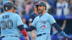 Toronto Blue Jays center fielder Kevin Kiermaier (39) celebrates with teammate Alejandro Kirk (30) after scoring during fourth inning American League MLB baseball action against the Tampa Bay Rays in Toronto, Saturday, Sept. 30, 2023. THE CANADIAN PRESS/Frank Gunn 