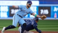 Tampa Bay Rays catcher Christian Bethancourt (14) is safe at third base after Toronto Blue Jays shortstop Bo Bichette (11) can't get to the throw during sixth inning American League MLB baseball action in Toronto, Saturday, Sept. 30, 2023. THE CANADIAN PRESS/Frank Gunn 