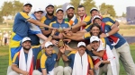Europe's Team Captain Luke Donald, centre, and team members lift the Ryder Cup after winning the trophy by defeating the United States 16/12 point to 11 1/2 points at the Marco Simone Golf Club in Guidonia Montecelio, Italy, Sunday, Oct. 1, 2023. (AP Photo/Alessandra Tarantino)