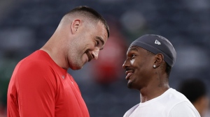 Kansas City Chiefs tight end Travis Kelce, left, talks with New York Jets wide receiver Mecole Hardman Jr. before playing in an NFL football game, Sunday, Oct. 1, 2023, in East Rutherford, N.J. (AP Photo/Adam Hunger)