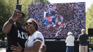 Kevin and Ursula Jones take a photo together in front of a video screen while attending the celebration for President Jimmy Carter's 99th birthday held at The Carter Center in Atlanta on Saturday, Sept. 30, 2023. (AP Photo/Ben Gray)
