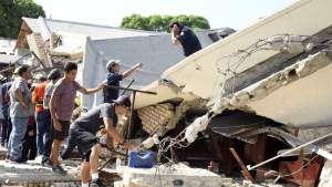 Rescue workers search for survivors amid debris after the roof of a church collapsed during a Sunday Mass in Ciudad Madero, Mexico, Sunday, Oct. 1, 2023. The Bishop of the Roman Catholic Diocese of Tampico said the roof caved in while parishioners were receiving communion. (Jose Luis Tapia/El Sol de Tampico via AP)