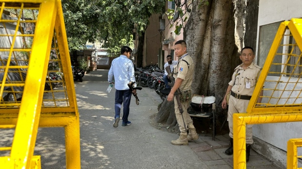 Security officers stand guard outside the office of Delhi Police's Special Cell in New Delhi, India, Tuesday, Oct. 3, 2023. Indian police raided the offices of a news website that's under investigation for receiving funds from China, as well as the homes of several of its journalists, in what critics described as an attack on one of India's few remaining independent news outlets. The raids came months after Indian authorities searched the BBC's New Delhi and Mumbai offices over accusations of tax evasion in February. (AP Photo/Piyush Nagpal)
