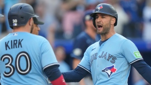 Toronto Blue Jays center fielder Kevin Kiermaier (39) celebrates with teammate Alejandro Kirk (30) after scoring during fourth inning American League MLB baseball action against the Tampa Bay Rays in Toronto, Saturday, Sept. 30, 2023. THE CANADIAN PRESS/Frank Gunn