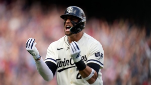 Minnesota Twins' Royce Lewis reacts after hitting a two-run home run during the first inning in Game 1 of an AL wild-card baseball playoff series against the Toronto Blue Jays Tuesday, Oct. 3, 2023, in Minneapolis. (AP Photo/Abbie Parr)