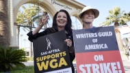 Fran Drescher, left, president of SAG-AFTRA, and Meredith Stiehm, president of Writers Guild of America West, pose together during a rally by striking writers outside Paramount Pictures studio in Los Angeles on May 8, 2023. (AP Photo/Chris Pizzello, File)