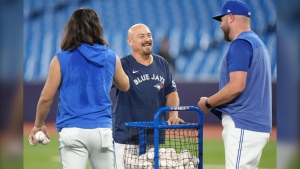 Toronto Blue Jays bullpen catcher Alex Andreopoulos shares a joke with Manager John Schneider and shortstop Bo Bichette during a practice session ahead of the Jays game against Tampa Bay Rays in American League MLB baseball action in Toronto, Friday, Sept. 29, 2023. THE CANADIAN PRESS/Chris Young