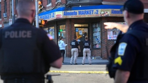 Law enforcement officials investigate the scene where multiple were shot, Wednesday, Oct. 4, 2023, in Holyoke, Mass. State police say at least three people, including a person riding a bus, were shot Wednesday in Holyoke following a fight on a downtown street. (AP Photo/Steven Senne)