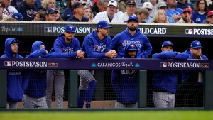 Toronto Blue Jays players watch from the dugout during the eighth inning of Game 2 of an AL wild-card baseball playoff series against the Minnesota Twins Wednesday, Oct. 4, 2023, in Minneapolis. (AP Photo/Abbie Parr)
