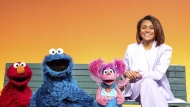 This image released by Sesame Workshop shows Ariana DeBose, right, with muppet characters, from left, Elmo, Cookie Monster and Abby Cadabby on the set of the children's show "Sesame Street." (Richard Termine/Sesame Workshop via AP)