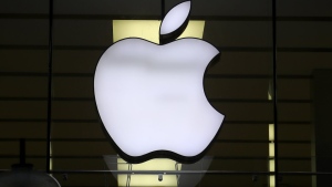 FILE - The Apple logo is illuminated at a store in the city center of Munich, Germany, Dec. 16, 2020. Apple Inc. is raising the prices for its AppleTV+ streaming and Arcade gaming plans, as well as its bundled Apple One service that includes streaming, music and other subscriptions. (AP Photo/Matthias Schrader, File)