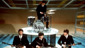 FILE -The Beatles, foreground from left, Paul McCartney, George Harrison, John Lennon and Ringo Starr on drums perform on the CBS "Ed Sullivan Show" in New York on Feb. 9, 1964. Sixty years after the onset of Beatlemania and with two of the quartet now dead, artificial intelligence has enabled the release of a "new" Beatles song "Now And Then" will be available Thursday, Nov. 2. (AP Photo/File)