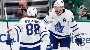 Toronto Maple Leafs defenseman Morgan Rielly (44) is congratulated by forward William Nylander (88) after scoring a goal against the Dallas Stars during the first period of an NHL hockey game Thursday, Oct. 26, 2023, in Dallas. (AP Photo/Brandon Wade)