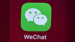 Icon for the smartphone apps WeChat is shown on a smartphone screen in Beijing, on Aug. 7, 2020. The federal government is banning WeChat and Kaspersky applications from its phones over security concerns. THE CANADIAN PRESS/AP/Mark Schiefelbein