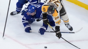 Toronto Maple Leafs defenseman Mark Giordano (55) and Boston Bruins left wing Jake DeBrusk, right, vie for control of the puck in the third period of an NHL hockey game, Thursday, Nov. 2, 2023, in Boston. (AP Photo/Steven Senne)