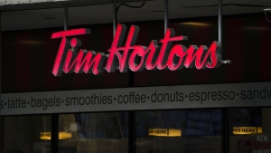 A woman is suing Tim Hortons after she says a staff mistake at a Winnipeg location led to a severe allergic reaction that resulted in her heart stopping for several minutes. Tim Hortons signage is pictured in Ottawa on Wednesday Sept. 7, 2022. THE CANADIAN PRESS/Sean Kilpatrick