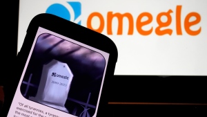 This photo, in New York, Thursday, Nov. 9, 2023, shows the Omegle logo, and their website posting on a mobile phone. Omegle, a video chat service that connects users with strangers at random, is shutting down after 14 years following ample misuse of the platform particularly the sexual abuse of minors. (AP Photo/Richard Drew)