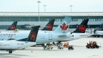 FILE - Air Canada planes sit on the tarmac at Pearson International airport during the COVID-19 pandemic in Toronto on Wednesday, Oct. 14, 2020. THE CANADIAN PRESS/Nathan Denette 