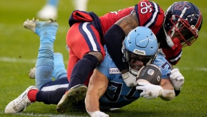 Toronto Argonauts running back AJ Ouellette (34) gets taken down by Montreal Alouettes linebacker Tyrice Beverette (26) during first half CFL Eastern Division final football action in Toronto, Saturday, Nov. 11, 2023. THE CANADIAN PRESS/Frank Gunn
