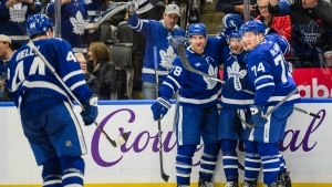 Toronto Maple Leafs centre Noah Gregor (18) celebrates with teammates after scoring during second period NHL hockey action against the Vancouver Canucks, in Toronto on Saturday, Nov. 11, 2023. THE CANADIAN PRESS/Christopher Katsarov