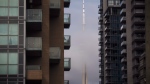 FILE - The CN Tower can be seen behind condos in Toronto's Liberty Village community in Toronto on Tuesday, April 25, 2017. THE CANADIAN PRESS/Cole Burston 
