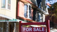 The Canadian Real Estate Association says the number of homes that changed hands last month was up 0.9 per cent compared with October 2022 as the national average home price rose to $656,625 — up 1.8 per cent from a year ago. A real estate sign is displayed in front of a house in Toronto on Wednesday, September 29, 2021. THE CANADIAN PRESS/Evan Buhler