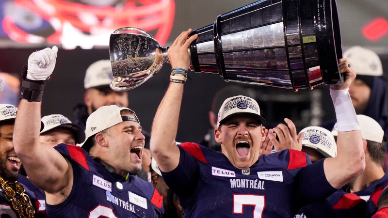 Montreal Alouettes quarterback Cody Fajardo (7) hoists the Grey Cup as fullback Alexandre Gagne (34) looks on as the Alouettes celebrate defeating the Winnipeg Blue Bombers in the 110th CFL Grey Cup in Hamilton, Ont., on Sunday, November 19, 2023. THE CANADIAN PRESS/Frank Gunn